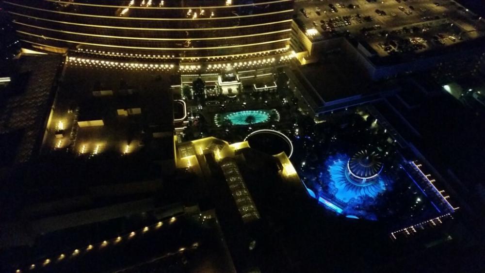 View from the 59th floor of The Wynn Hotel in Las Vegas, looking down onto pools and a large fountain.